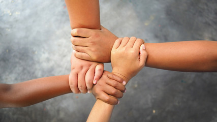 Young children join hands to best friendship forever, collaboration of   business and education teamwork concept for backgrounds