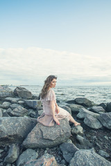 Fototapeta na wymiar Young cute woman relaxing on ocean coast