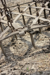 Harrows close-up on the arable field of agricultural land