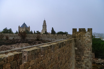 Fototapeta na wymiar Old town wall and Franciscan monastery of dormition on mount Zion in Jerusalem, Israel