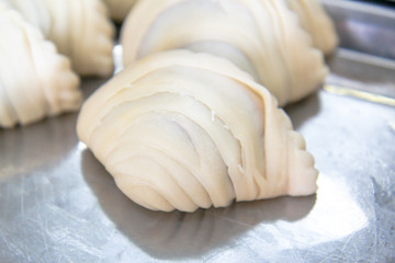empanadas lined up before fried, curry puff ready to fried on table
