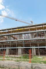 Naklejka premium Scaffolds and cranes in a construction site