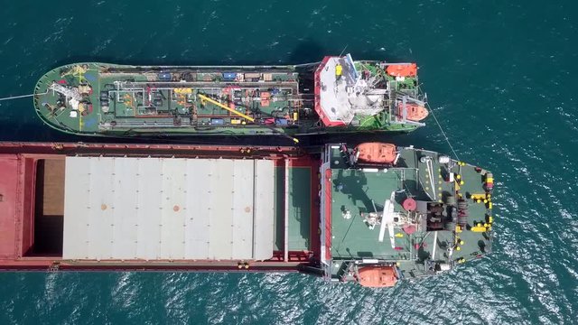 Refuelling at sea, Aerial footage of a Small Oil products ship fuelling a large Bulk carrier.