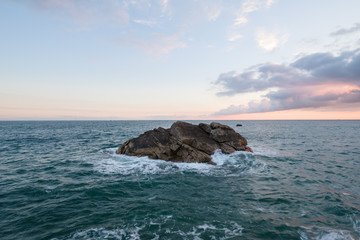 Large rock in the sea during sunrise, France, Brittany, Finistere 