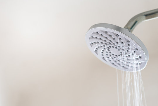 Leaking water from a shower head. Concept of water wastage