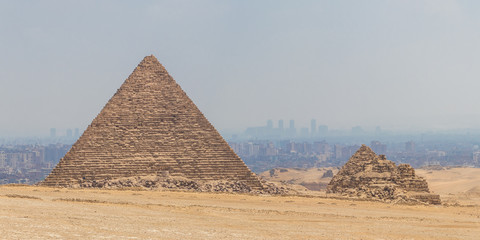 Fototapeta na wymiar The beautiful view of the Great Pyramid of Menkaure in the Giza Pyramid Complex on background Cairo city skyline