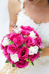 Obraz na płótnie Canvas bride holding a purple and white wedding bouquet of flowers. Bride with wedding bouquet 