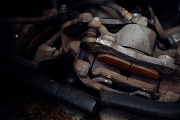 Disc brake and asbestos brake pads at car garage