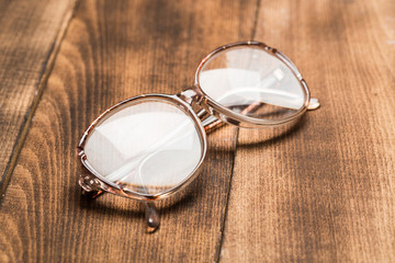 old glasses on wooden surface