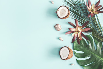 Summer composition. Tropical palm leaves, coconut on pastel blue background. Summer concept. Flat lay, top view, copy space - Powered by Adobe