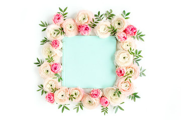 Floral pattern frame made of pink ranunculus and roses flower buds on white background with space for text.  Flat lay, top view floral background.