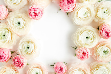Floral background frame made of pink ranunculus and roses flower buds on white background.  Flat lay, top view floral background.