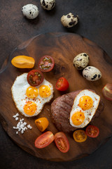 Rustic wooden serving board with marbled beef steak cooked in tuscan style, vertical shot, top view