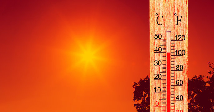 Summer heat. Thermometer display plus 40 degrees celsius. Orange sun in red sky