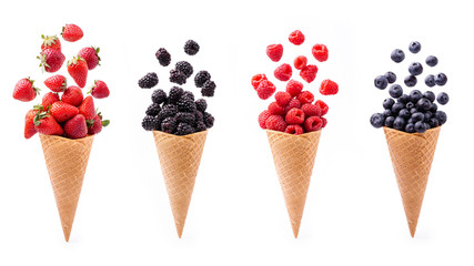 In the foreground, lively variety of berries in ice cream cones, isolated from the white background