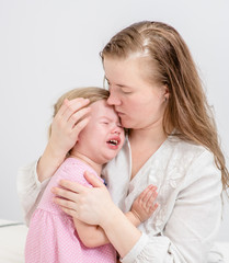 Mother calming her crying baby girl