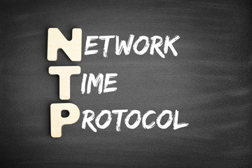 Obraz premium Wooden alphabets building the word NTP - Network Time Protocol acronym on blackboard