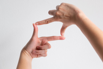 symbol of camera frame by using thumb and forefinger of two hands.