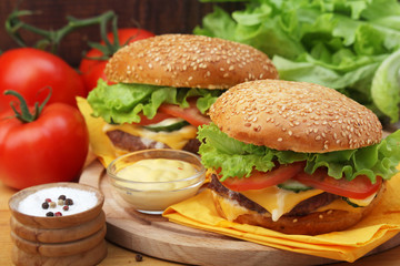 Two fresh hamburgers with vegetables	