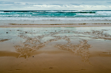 Fototapeta na wymiar Dramatic ocean waves on the sand beach in Australia