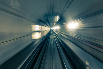 Motion blurred shot taken from a front car train running inside a tunnel