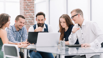 business team discusses new ideas sitting at the office Desk