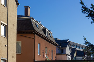 Fototapeta na wymiar city house rooftops with chimney and antenna