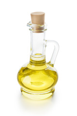 Olive oil in glass jug on white