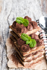 Homemade chocolate layered cakes on wooden table