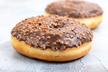 Donut Filled With Chocolate Topping On The Blue Background