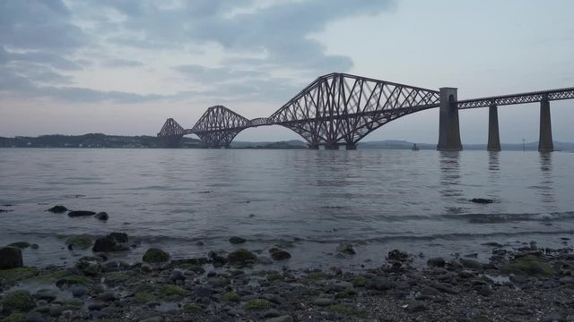Forth bridges at sunset. The Forth Bridge is a cantilever railway bridge near Edinburgh, Scotland. It was opened in March 1890. It was the first major structures in Britain to be constructed of steel