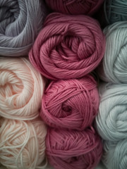 Skeins with different colors of threads for knitting, for needlework