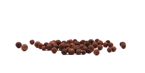 Detailed view of a pile of allspice. Spices isolated on white background.