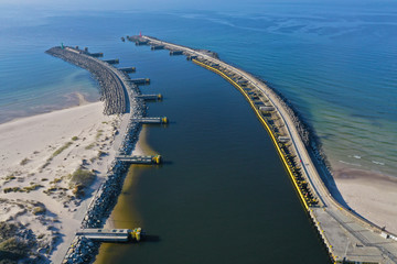 Aerial perspective view on sea breakwaters and ship port entrance.