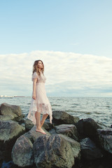 Cute woman on ocean coast, portrait