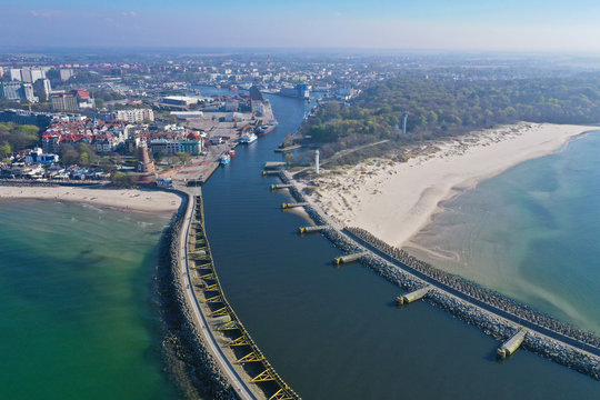Aerial view on Kolobrzeg cityscape with lighthouse, ship port, port entrance and breakwaters
