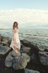 Fototapeta na wymiar Beautiful woman wearing boho dress on ocean coast, romantic beauty portrait