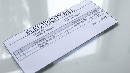 Electricity bill lying on table, payment for services, month expenses, tariff