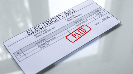Fototapeta premium Paid seal stamped on electricity bill, payment for services, month expenses