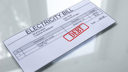 Fototapeta premium Debt seal stamped on electricity bill, payment for services, month expenses