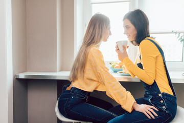 a couple of lesbians having breakfast enjoying the morning time. close up photo. pleasant conversation with best friend.