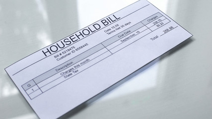 Household bill lying on table, payment for services, month expenses, tariff