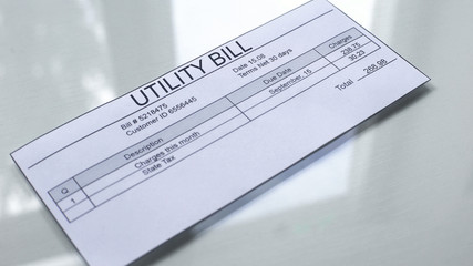 Utility bill lying on table, payment for services, month expenses, tariff