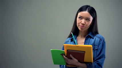 Busy asian woman writing down her plans and ideas, daily planning, to-do list
