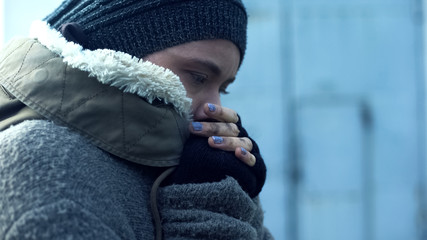 Poor woman in dirty clothes feeling cold, homeless lifestyle, hopelessness