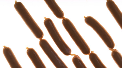 Raw sausages on white background, food quality, unhealthy meal, gastronomy