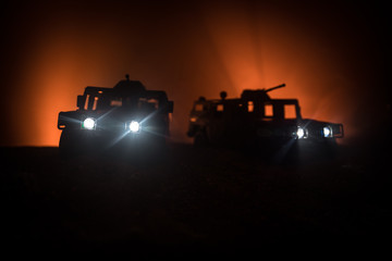 War Concept. Military silhouettes fighting scene on war fog sky background, Fighting silhouettes Below Cloudy Skyline At night. Battle scene. Army vehicle with soldiers. army