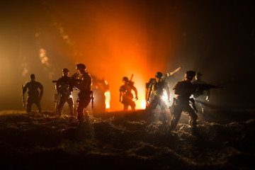 Fototapeta premium War Concept. Military silhouettes fighting scene on war fog sky background, Fighting silhouettes Below Cloudy Skyline At night. Battle scene. Army vehicle with soldiers. army