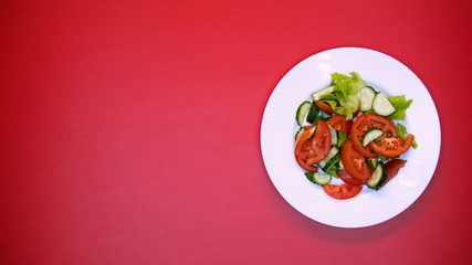 Vegetable salad on white plate bright background, healthy nutrition, vitamins