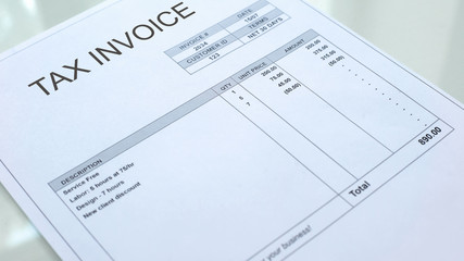 Tax invoice commercial document lying on table, business accounting, template